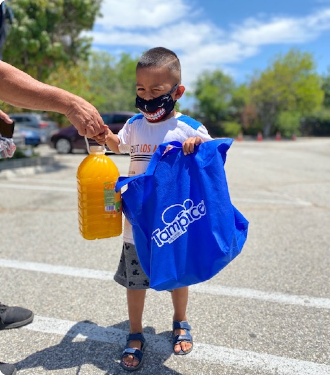 Little boy holding Tampico punch and shopping bag